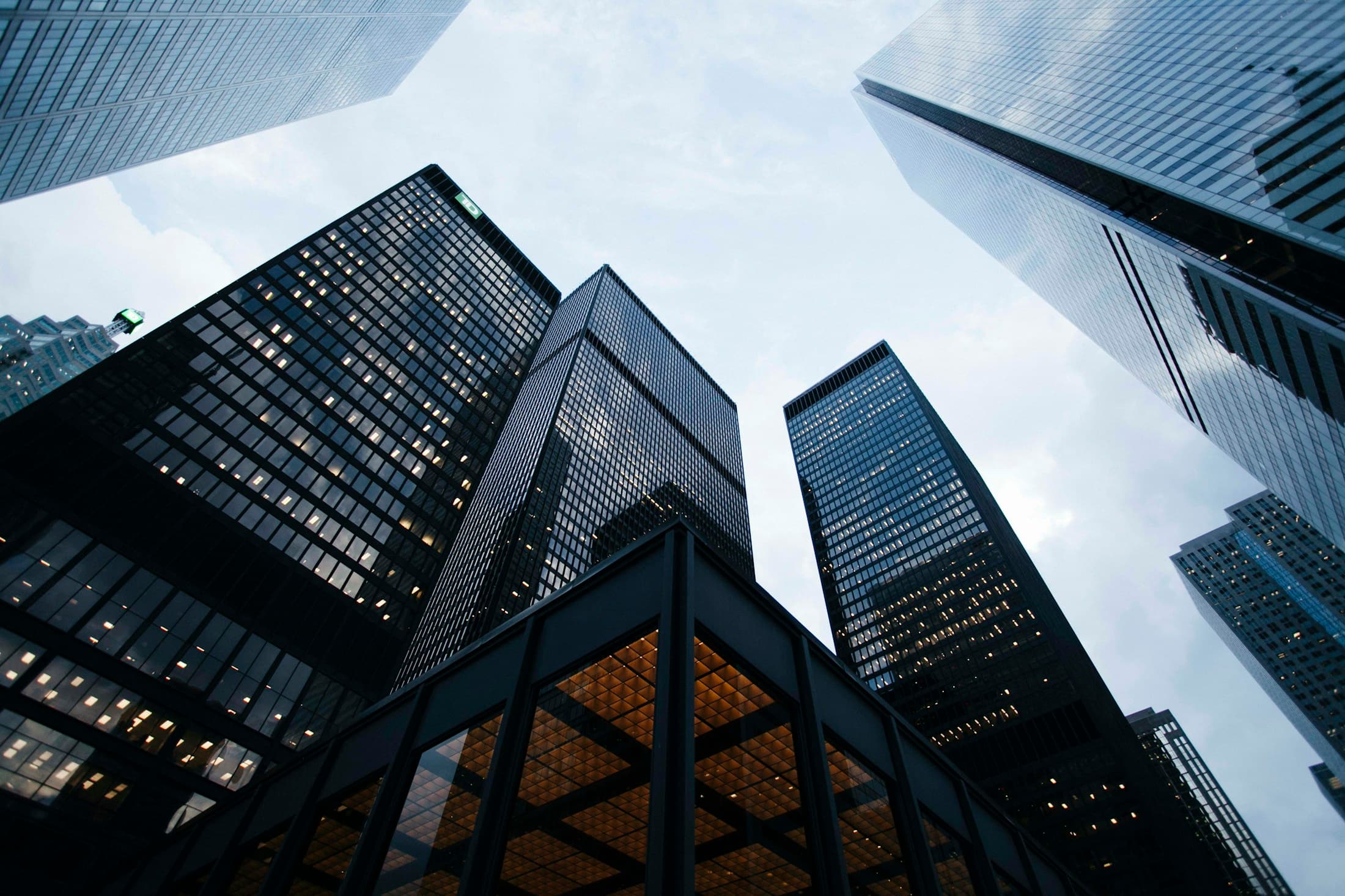 Modern glass towers rising toward an open sky
